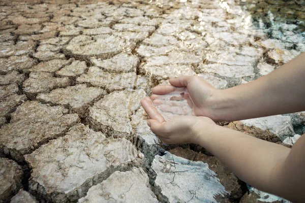 Mano de niño en tierra seca agrietada, Concepto sequía y crisis en — Foto de Stock