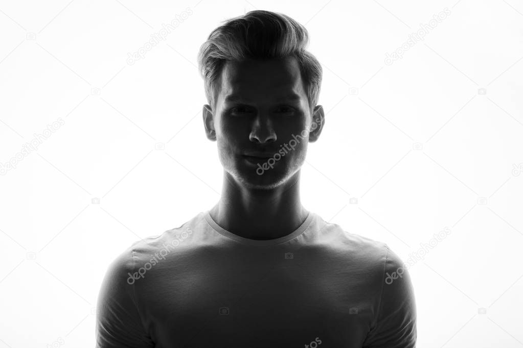 monochrome portrait of young handsome man posing on white background