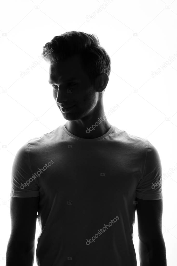 monochrome portrait of young handsome man posing on white background