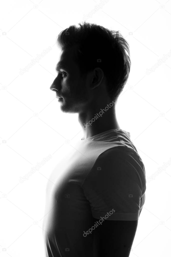 silhouette of young man posing on white background, side view