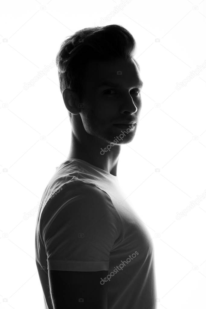 silhouette of young man posing on white background