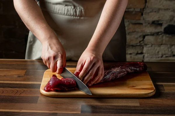 Woman cutting meat Stock Photos, Royalty Free Woman cutting meat Images