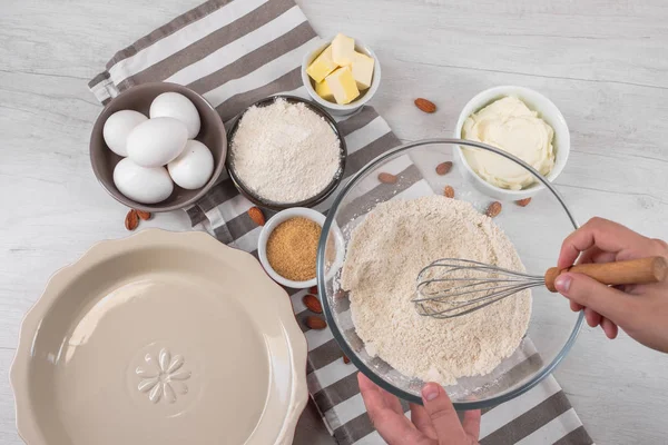 Chef malzemeler mutfak masasında yemeklerle tatlı cheesecake yemek