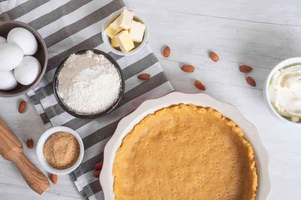 Baking sweet cheesecake with cooking ingredients on kitchen table