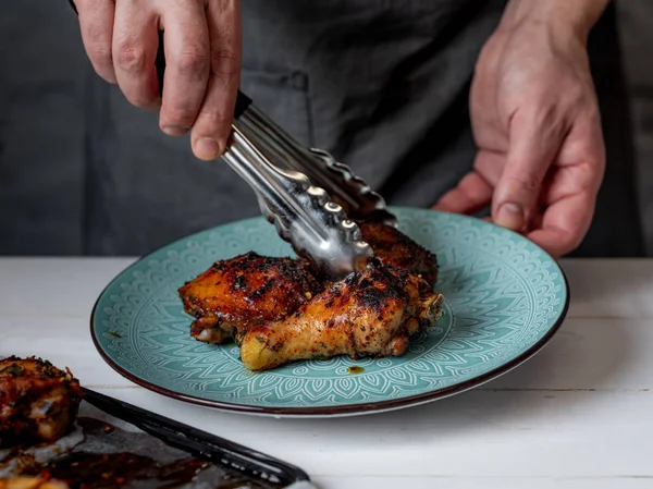 Hombre Poniendo Patas Pollo Recién Horneadas Con Fórceps Plato Azul — Foto de Stock