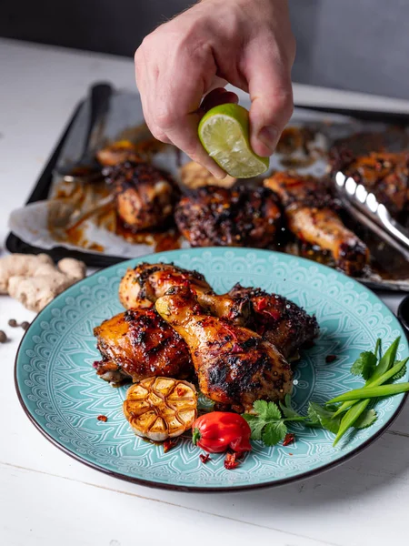 Chef Sprinkling Lime Juice Spice Chicken Legs — Free Stock Photo