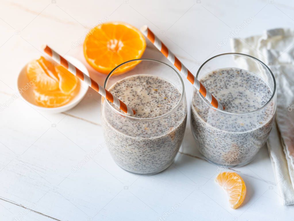 Fresh chia pudding served with ripe tangerine slices on wooden table 