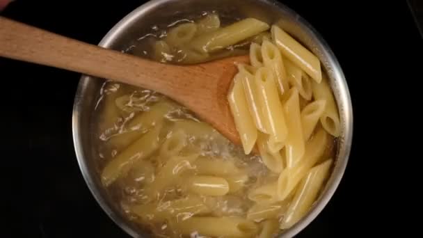 Close View Man Folding Boiling Penne Pasta Saucepan — Stock Video