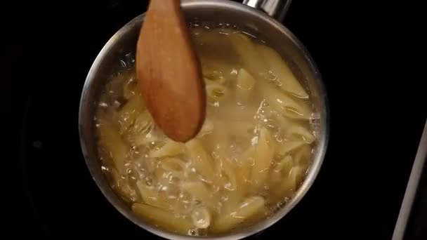 Close View Man Folding Boiling Penne Pasta Saucepan — Stock Video