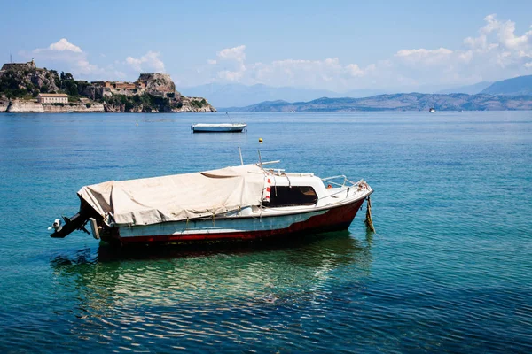 Boat trip along river in Corfu Greece. Ship on clean blue water. Island houses on the shore view. Greek beautiful landscape. White boats sailing. Relaxation, traveling