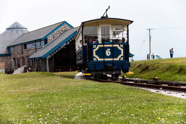 Tramway arriving to the station at the foot of the line. Train reached the destination. View from the back to the moving tramway on the funicular railroad