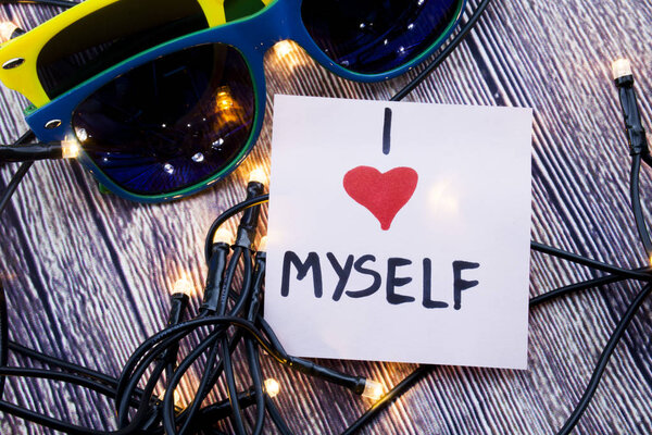 I love myself concept handwritten on the paper with wooden background. Emotional and love concept with retro background. Egoistic concept with I love myself words