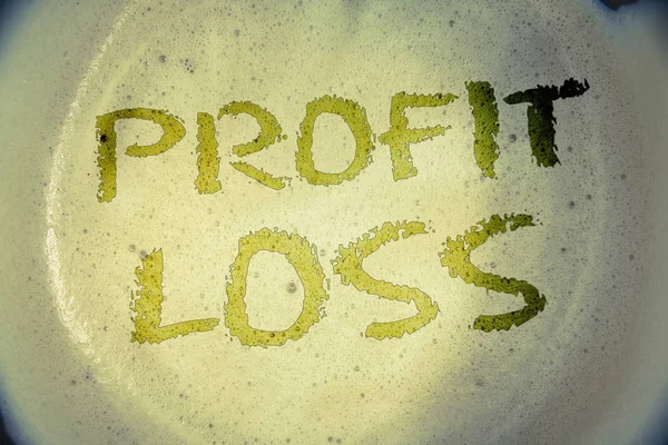 Writing note showing  Profit Loss. Business photo showcasing Financial year end account contains total revenues and expensesIdeas messages concepts words letters created foamy coffee background