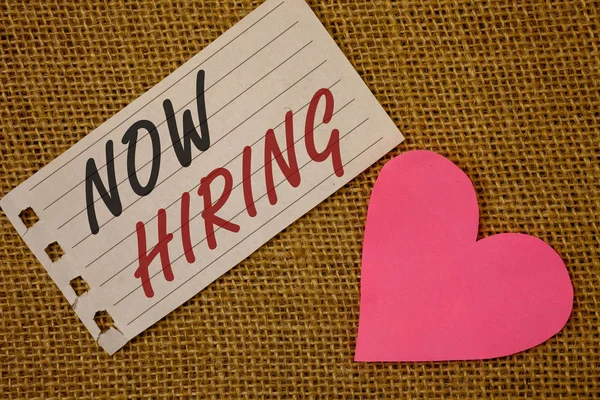 Text sign showing Now Hiring. Conceptual photo Workforce Wanted Employees Recruitment Today Job OpportunityNotebook page Wicker background Pink Heart Black Red letters Love note