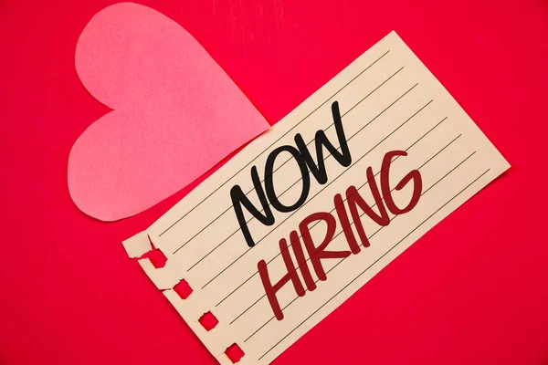Text sign showing Now Hiring. Conceptual photo Workforce Wanted Employees Recruitment Today Job OpportunityNotebook page red background Pink Heart Black letters Love note romantic