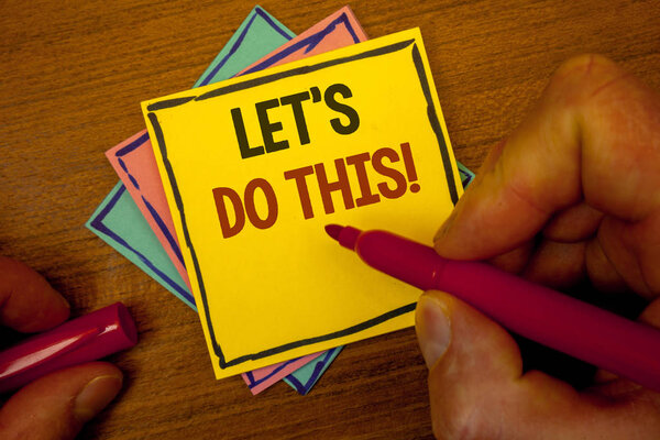 Conceptual hand writing showing Let Us Do This Motivational Call. Business photo text Encourage to start something Inspirational Text colorful paper notes hand red marker open cap desk letter