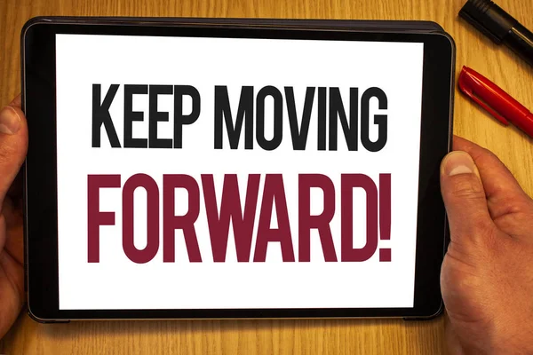 Handwriting text Keep Moving Forward Motivational Call. Concept meaning Optimism Progress Persevere Move Hand hold showing colorful letters black marker red pen timber carrel