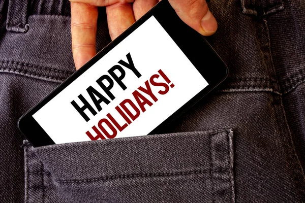 Conceptual hand writing showing Happy Holidays Motivational Call. Business photo showcasing Greeting Celebrating Festive Days Man holding cell phone white screen letters jeans pocket