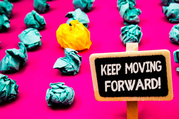 Conceptual hand writing showing Keep Moving Forward Motivational Call. Business photo text Optimism Progress Persevere Move Blackboard with white letter pink base much green paper lobs