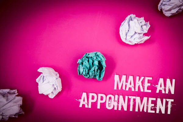 Handwriting text Make An Appointment. Concept meaning Schedule Arrangement Deadline Session Engagement Light pink floor circled shadow ruffled white paper balls middle green ball