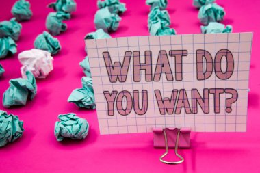 Conceptual hand writing showing What Do You Want Question. Business photo showcasing Aspiration Contemplation Need Contemplate Aspire Paperclip with pink letters pink ground green paper lobs clipart