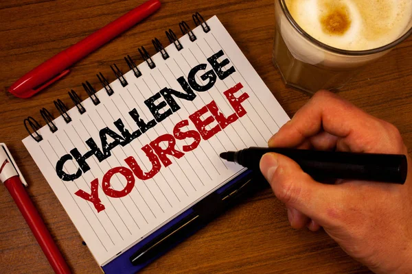 Word writing text Challenge Yourself. Business concept for Overcome Confidence Strong Encouragement Improvement Dare Hand grasp black marker wooden desk red pen notepad expos texts coffee