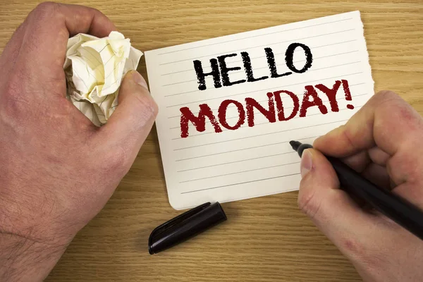 Handwriting text Hello Monday Motivational Call. Concept meaning Positive Message for a new day Week Start Text two words white paper note black marker hand crumbled paper note