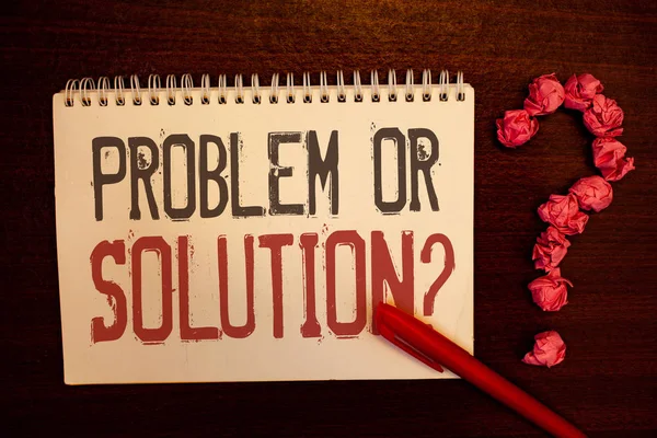 Handwriting text Problem Or Solution Question. Concept meaning Think Solve Analysis Solving Conclusion Reddish paper balls structures question mark red pen notebook browny desk