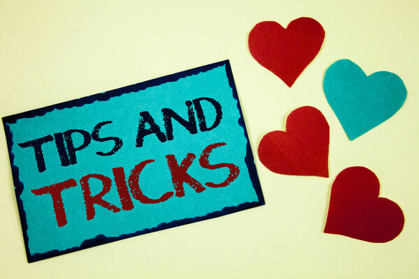 Word writing text Tips And Tricks. Business concept for Suggestions to Make things easier Helpful Advices Solutions Turquoise note ideas black red letters words hearts frame beige background