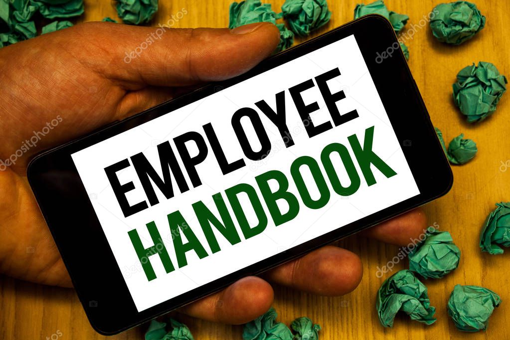 Handwriting text Employee Handbook. Concept meaning Document Manual Regulations Rules Guidebook Policy Code Hand holding phone white screen written words crumbled green notes paper