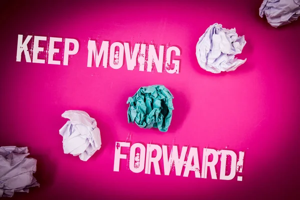 Handwriting text Keep Moving Forward Motivational Call. Concept meaning Optimism Progress Persevere Move Light pink floor circled shadow ruffled white paper balls middle green ball