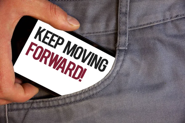 Word writing text Keep Moving Forward Motivational Call. Business concept for Optimism Progress Persevere Move Personage hand pushing mobile phone into back pocket fascinating way