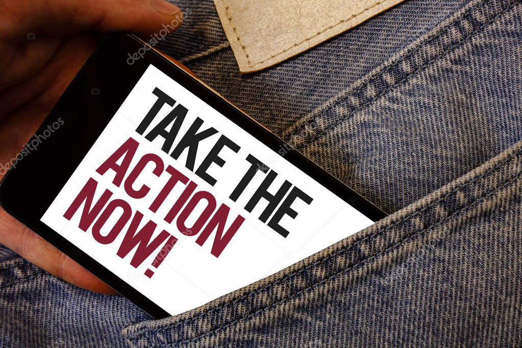 Writing note showing  Take The Action Now Motivational Call. Business photo showcasing Act Start Promptly Immediate Instantly Human hand bring out cell phone with colorful text jeans back pocket