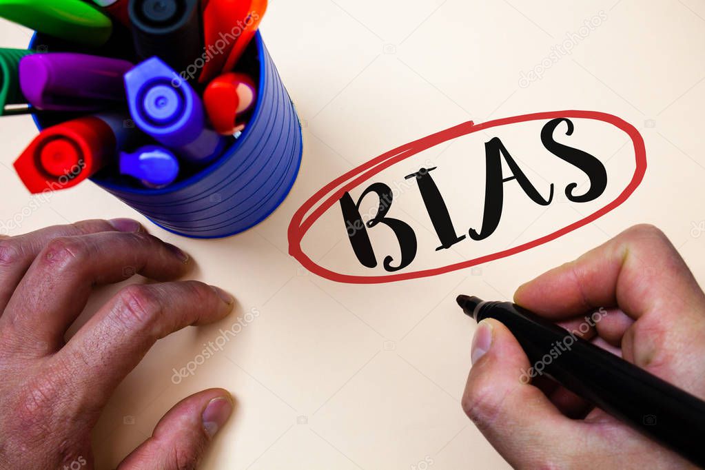 Conceptual hand writing showing Bias. Business photo text Unfair Subjective One-sidedness Preconception Inequality Bigotry Man holding black marker markers table ideas message communicate
