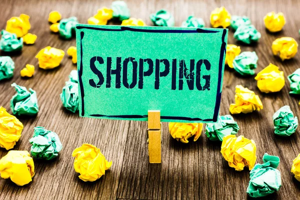 Conceptual hand writing showing Shopping. Business photo showcasing Shopper customer purchase goods products store experience Crumpled papers ideas mistakes paperclip clip objects wood