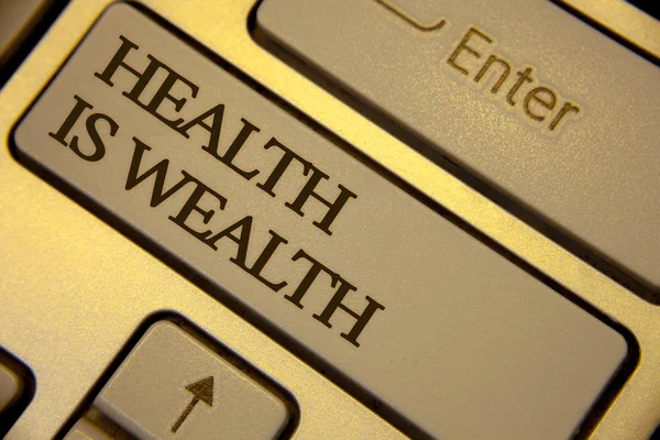 Conceptual hand writing showing Health Is Wealth. Business photo text being in good shape great value Stay healthy eat Healthy Keyboard grey keys yellow background computer message keypad