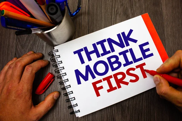 Text sign showing Think Mobile First. Conceptual photo Handheld devises marketing target portable phones first Penholder notepad marker feelings ideas appointments information important
