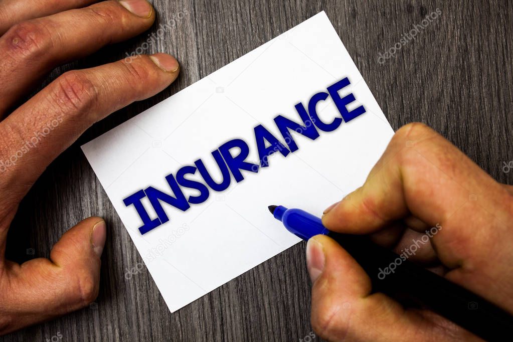 Conceptual hand writing showing Insurance. Business photo showcasing Policy for financial protection or reimbursement against losses Man working holding blue marker ideas paper wooden table