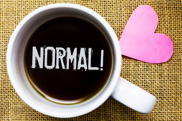 Text sign showing Normal Motivational Call. Conceptual photo conforming to a standard Usual Typical or Expected Tea time coffee cup office typing work jute rough background love heart