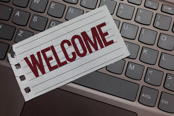 Writing note showing Welcome. Business photo showcasing Warm salutation acknowledgement for someone amiable loved thanked Keyboard colour grey paper keys laptop creative idea computer keypad