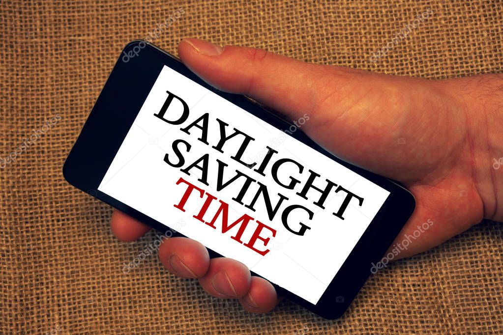 Word writing text Daylight Sayving Time. Business concept for advancing clocks during summer to save electricity Owner hold holding smartphone white screen message application intention