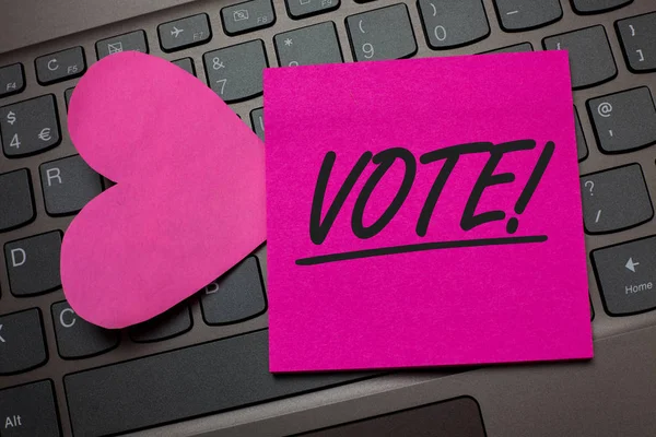 Conceptual hand writing showing Vote Motivational Call. Business photo text Formalized decision on important matters electing Keyboard grey keys pink paper love idea thought computer hart