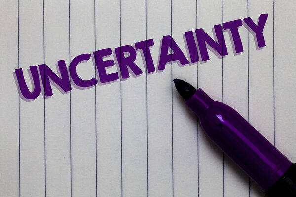 Text sign showing Uncertainty. Conceptual photo Unpredictability of certain situations events behavior Notepad marker pen ideas thoughts white paper important black shadow