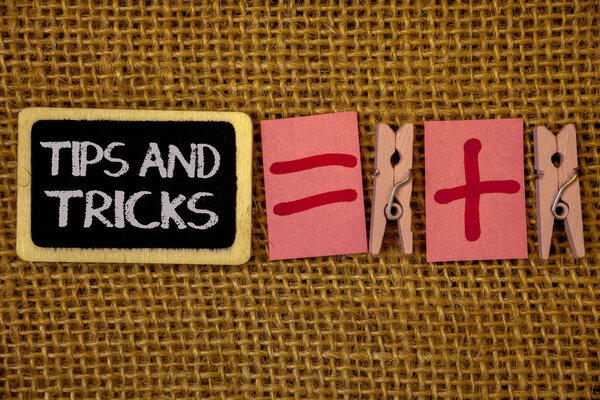 Writing note showing  Tips And Tricks. Business photo showcasing Suggestions to Make things easier Helpful Advices Solutions Ideas on blackboard chalk letters equal plus signs cloth pins wicker