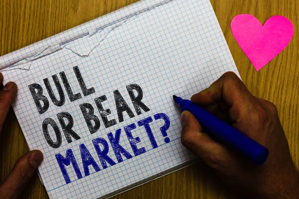 Handwriting text Bull Or Bear Market question. Concept meaning asking someone about his marketing method Paper register multiline text pen handwriting love heart table background