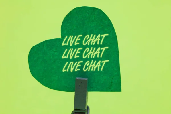Conceptual hand writing showing Live Chat Live Chat Live Chat. Business photo showcasing talking with people friends relatives online Clothespin holding green paper heart romantic message ideas