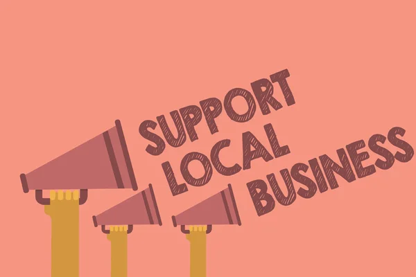 Writing note showing Support Local Business. Business photo showcasing increase investment in your country or town Hands holding megaphones loudspeaker important message pink background
