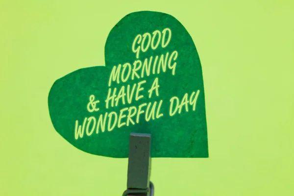 Conceptual hand writing showing Good Morningand Have A Wonderful Day. Business photo showcasing greeting someone in start of the day Clothespin holding green paper heart romantic message ideas. — Stock Photo, Image