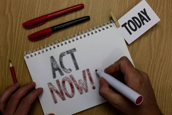 Conceptual hand writing showing Act Now. Business photo showcasing Having fast response Asking someone to do action Dont delay Man holding marker notebook reminder wooden table cup coffee