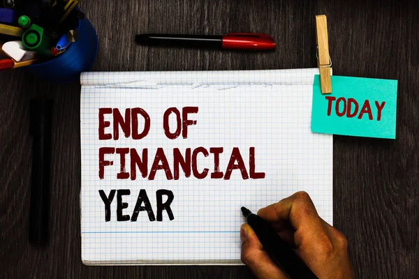 Conceptual hand writing showing End Of Financial Year. Business photo text Revise and edit accounting sheets from previous year Register pages handwriting text work stationery items woody table